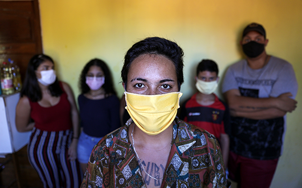 Woman who is now unemployed because of the pandemic, shown with her family.