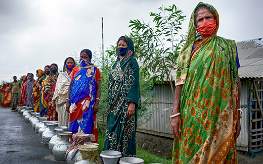 Villagers line up to receive safe drinking water.
